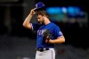 Texas Rangers' Jordan Lyles adjusts his cap after giving up a run to the Arizona Diamondbacks during the third inning of a baseball game, Tuesday, Sept. 7, 2021, in Phoenix. (AP Photo/Matt York)