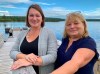 Barbara Pritchett, left, and Carol Anne Loveless, right, stand on a deck in front of the Gambo River in Gambo, N.L., on Friday, Sept. 3, 2021. They co-wrote a play documenting the massive efforts undertaken by the people of Gambo to look after hundreds of passengers whose planes were rerouted to the nearby town of Gander on Sept. 11, 2001. THE CANADIAN PRESS/Sarah Smellie