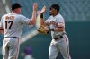 San Francisco Giants relief pitcher Jake McGee, left, congratuates right fielder LaMonte Wade Jr. after the team's baseball game against the Colorado Rockies on Wednesday, Sept. 8, 2021, in Denver. The Giants won 7-4. (AP Photo/David Zalubowski)
