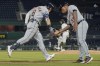 Detroit Tigers' Robbie Grossman (8) is greeted by third base coach Ramon Santiago as he runs the bases after hitting a solo home run off Pittsburgh Pirates relief pitcher Cody Ponce, center, during the seventh inning of a baseball game Wednesday, Sept. 8, 2021, in Pittsburgh. (AP Photo/Keith Srakocic)