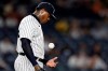 New York Yankees pitcher Aroldis Chapman tosses the ball as he waits to be taken out of the baseball game against the Toronto Blue Jays during the ninth inning Wednesday, Sept. 8, 2021, in New York. The Blue Jays won 6-3. (AP Photo/Adam Hunger)