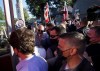 A person, top right, throws gravel at Liberal leader Justin Trudeau, left, as the RCMP security detail provide protection, while protesters shout at a local microbrewery during the Canadian federal election campaign in London, Ont., Monday, Sept. 6, 2021. The People's Party of Canada says it has removed its president of the Elgin Middlesex London riding association after a handful of gravel was thrown at Liberal Leader Justin Trudeau during a campaign stop in London, Ont., earlier this week. THE CANADIAN PRESS/Nathan Denette