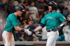 Seattle Mariners' Tom Murphy, right, is greeted by Dylan Moore after Murphy hit a solo home run during the sixth inning of the team's baseball game against the Arizona Diamondbacks, Friday, Sept. 10, 2021, in Seattle. The homer was Murphy's second in the game. (AP Photo/Ted S. Warren)