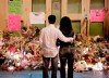 A couple observe a public memorial at the scene of the Dawson College shootings in the early morning of Sunday, Sept. 17, 2006. Survivors and families of Montreal's Dawson College shooting victims in Quebec are urging Canadians against voting for the Conservatives and party leader Erin O'Toole. THE CANADIAN PRESS/Ian Barrett