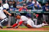 Boston Red Sox's Rafael Devers, right, scores as Seattle Mariners catcher Tom Murphy waits for the ball in the 10th inning of a baseball game Wednesday, Sept. 15, 2021, in Seattle. (AP Photo/Elaine Thompson)