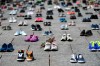 Dried flowers rest inside a pair of child's running shoes at a memorial for the 215 children whose remains were found at the grounds of the former Kamloops Indian Residential School at Tk’emlups te Secwépemc First Nation in Kamloops, B.C., on Parliament Hill in Ottawa on Friday, June 4, 2021. THE CANADIAN PRESS/Justin Tang