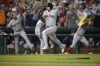 Boston Red Sox' s Jose Iglesias runs toward home to score on a triple by Christian Vazquez during the ninth inning of a baseball game against the Washington Nationals, Saturday, Oct. 2, 2021, in Washington. (AP Photo/Nick Wass)