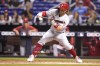 Philadelphia Phillies' Bryce Harper bunts for a single during the fourth inning of a baseball game against the Miami Marlins, Saturday, Oct. 2, 2021, in Miami. (AP Photo/Lynne Sladky)