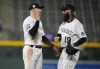 Colorado Rockies shortstop Trevor Story, left, is congratulated by right fielder Charlie Blackmon after the ninth inning of a baseball game Wednesday, Sept. 29, 2021, in Denver. The Rockies posted a 10-5 victory over the Washington Nationals. (AP Photo/David Zalubowski)