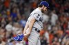 FILE- In this May 26, 2021, file photo, Los Angeles Dodgers starting pitcher Trevor Bauer walks back to the mound after giving up a solo home run to Houston Astros' Carlos Correa in the sixth inning of a baseball game in Houston. Bauer will miss the rest of the season. Major League Baseball and the players' association extended his administrative leave through the end of the World Series on Friday, Sept. 10 2021. Bauer was placed on seven days’ paid leave July 2 under the joint domestic violence, sexual assault and child abuse policy adopted by MLB and the players’ union. (AP Photo/Eric Christian Smith, File)