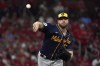 Milwaukee Brewers starting pitcher Brandon Woodruff throws to first during the first inning of a baseball game against the St. Louis Cardinals Tuesday, Sept. 28, 2021, in St. Louis. (AP Photo/Jeff Roberson)