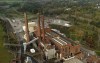 Smokestacks from the Greenridge Generation power plant tower above nearby homes, Friday, Oct. 15, 2021, in Dresden, N.Y. One Bitcoin mining operation in central New York came up with a novel solution in finding cheap energy to run the power-gobbling computer arrays that create and transact cryptocurrency: It took over Greenidge Generation which now produces about 44 megawatts to run 15,300 computer servers, plus additional electricity it sends into the state's power grid. (AP Photo/Julie Jacobson)