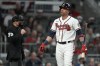 Atlanta Braves' baseman Ehire Adrianza reacts after striking out in the eighth inning against the Los Angeles Dodgers in Game 1 of baseball's National League Championship Series Saturday, Oct. 16, 2021, in Atlanta. (AP Photo/Ashley Landis)