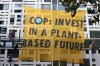 Environmental protesters attach themselves to the outside of the building which contains the Home Office and the Department for Environment, Food & Rural Affairs in Westminster in London, Tuesday, Oct. 26, 2021. The demonstrators from Animal Rebellion are calling for a switch to plant based diets. (AP Photo/Kirsty Wigglesworth)