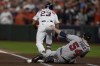 Houston Astros' Michael Brantley steps on Atlanta Braves starting pitcher Max Fried on the way to first during the first inning in Game 6 of baseball's World Series between the Houston Astros and the Atlanta Braves Tuesday, Nov. 2, 2021, in Houston. (AP Photo/Eric Gay)