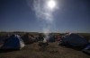 A fire burns at a homeless encampment set up in Wetaskiwin, Alta., Saturday, Oct. 9, 2021. The central Alberta city has taken another step to secure warming shelters for vulnerable individuals living in tents in an open field, but its mayor says they need some help. THE CANADIAN PRESS/Jason Franson