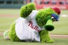 FILE - The Phillie Phanatic mascot works on the field before a baseball game between the Arizona Diamondbacks and the Philadelphia Phillies on June 16, 2017, in Philadelphia. The Phillie Phanatic is back and close to his original form after a lawsuit was settled with his creators. The Phanatic will be back in time for the 2022 season. (AP Photo/Chris Szagola, File)