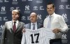 FILE - New York Yankees owner Hal Steinbrenner, left, general manager Brian Cashman, center, and Aaron Boone, pose for photographers during a news conference introducing Boone as the baseball team's new manager on Dec. 6, 2017, at Yankee stadium in New York. Steinbrenner praised general manager Brian Cashman and manager Aaron Boone on Wednesday, Nov. 17, 2021, and said he is open to a new contract for slugger Aaron Judge. (AP Photo/Mary Altaffer, File)
