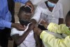 FILE - A child winces as he receives his Pfizer vaccine against COVID-19 in Diepsloot Township near Johannesburg, Thursday, Oct. 21, 2021. A new coronavirus variant has been detected in South Africa that scientists say is a concern because of its high number of mutations and rapid spread among young people in Gauteng, the country's most populous province. (AP Photo/Denis Farrell, File)