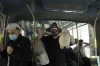 A man who opposes coronavirus vaccine mandates wears a mask altered to make a statement, poses with a toy sheep and an outsized syringe as he rides a crowded train in Jerusalem ahead of Shabbat, Friday, Nov. 26, 2021. Israel's prime minister says it is 