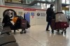 Passengers wait to get a COVID-19 test at Heathrow Airport in London, Monday, Nov. 29, 2021. The new potentially more contagious omicron variant of the coronavirus popped up in more European countries on Saturday, just days after being identified in South Africa, leaving governments around the world scrambling to stop the spread. In Britain, Prime Minister Boris Johnson said mask-wearing in shops and on public transport will be required, starting Tuesday. (AP Photo/Frank Augstein)