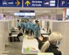 Healthcare workers wait for airline passengers at a COVID-19 testing center at Trudeau Airport in Montreal, Friday, Feb. 19, 2021. Unvaccinated travellers over the age of 12 won't be able to board a plane or train in Canada as of today, now that the grace period has ended on the government's COVID-19 vaccine mandate. THE CANADIAN PRESS/Ryan Remiorz