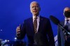 President Joe Biden speaks to members of the media before boarding Air Force One at Minneapolis-Saint Paul International Airport in Minneapolis, Tuesday, Nov. 30, 2021, after visiting Dakota County Technical College in Rosemount, Minn. (AP Photo/Carolyn Kaster)