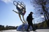 A visitor to the Shougang Park walks past the a sculpture for the Beijing Winter Olympics in Beijing, China, Tuesday, Nov. 9, 2021. China on Monday, Dec. 6, 2021, threatened to take 