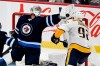 Winnipeg Jets' goaltender Connor Hellebuyck (37) makes a save on Nashville Predators’ Ryan Johansen (92) during the third period of NHL action in Winnipeg on Saturday, October 23, 2021. THE CANADIAN PRESS/Fred Greenslade