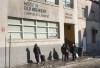 Homeless people stand outside the Old Brewery Mission in Montreal, on Monday, January 10, 2022. Homelessness sector staff continue to struggle to support those experiencing homelessness as the highly transmissible Omicron COVID-19 variant sweeps through communities. THE CANADIAN PRESS/Paul Chiasson