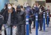 People wait in line at a COVID-19 vaccination site in Montreal, Sunday, Jan. 16, 2022, as the COVID-19 pandemic continues in Canada. The Omicron-fuelled fifth wave of the COVID-19 pandemic appears to be peaking in some provinces, while others say the worst is likely still to come. THE CANADIAN PRESS/Graham Hughes