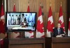 Minister of Crown-Indigenous Relations Marc Miller takes part in a blessing given virtually by elder Manitok Thompson, pictured on monitor, at the beginning of a press conference in Ottawa on Thursday, Jan. 20, 2022. THE CANADIAN PRESS/Sean Kilpatrick