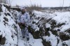 A serviceman stands holding his machine-gun in a trench on the territory controlled by pro-Russian militants at frontline with Ukrainian government forces in Slavyanoserbsk, Luhansk region, eastern Ukraine, Tuesday, Jan. 25, 2022. Ukraine's leaders sought to reassure the nation that a feared invasion from neighboring Russia was not imminent, even as they acknowledged the threat is real and prepared to accept a shipment of American military equipment Tuesday to shore up their defenses. THE CANADIAN PRESS/AP/Alexei Alexandrov