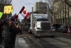 People gather in support of the trucker convoy protesting measures taken by authorities to curb the spread of COVID-19 and vaccine mandates at the Alberta Legislature in Edmonton on Saturday, Jan. 29, 2022. Alberta Premier Jason Kenney says a truck convoy that's blockaded a highway at a busy U.S. border crossing as part of a protest against vaccine mandates violates the province's Traffic Safety Act and must end immediately. THE CANADIAN PRESS/Jason Franson