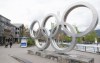 People walk past the Olympic rings in Whistler, B.C., Friday, May 15, 2020.&nbsp;An Indigenous-led partnership has taken the next step in exploring a potential bid to host the 2030 Winter Olympics and Paralympics.&nbsp;THE CANADIAN PRESS/Jonathan Hayward