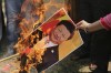 FILE-A Bharatiya Janata Party activist burns a photograph of Chinese President Xi Jinping during a protest in Jammu, India, Wednesday, July 1, 2020. India will not attend Friday's opening ceremony of the Beijing Winter Olympics, after one of the torchbearers reportedly chosen by Chinese authorities riled up New Delhi's anger. India's foreign affairs spokesman Arindam Bagchi on Thursday said it was 