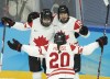 Canada forward Brianne Jenner (19) celebrates with teammates Claire Thompson (42) and Sarah Nurse (20) after scoring her second goal of the game during second period women's ice hockey action against the United States at the 2022 Olympic Winter Games, in Beijing, Tuesday, Feb. 8, 2022. THE CANADIAN PRESS/Ryan Remiorz