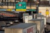 A small line of semi-trailer trucks line up along northbound I-75 in Detroit as the Ambassador Bridge entrance is blocked off for travel to Canada on Tuesday, Feb. 8, 2022. THE CANADIAN PRESS/Ryan Garza/Detroit Free Press via AP