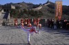 FILE - Wu Jingyu, China's Taekwondo Olympic champion, poses with a kick before taking part in the torch relay for the 2022 Winter Olympics at the Badaling Great Wall on the outskirts of Beijing, China, on Feb. 3, 2022. China has thousands of years of doing things in a really big way, reinforcing its perceived place in the world and the political power of its leaders — from emperors to Mao Zedong to Xi Jinping. None of this bigness is new. It goes back to a dozen dynasties that ruled China for thousands of years, a tradition of projecting power that was adopted by the Chinese Communist Party when it came to power in 1949. It could be termed simply: big, bigger and biggest — and then some. (AP Photo/Ng Han Guan, File)