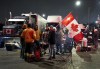 Truckers and supporters block the access leading from the Ambassador Bridge, linking Detroit and Windsor, as truckers and their supporters continue to protest against the COVID-19 vaccine mandates and restrictions in Windsor, Ont., on Wednesday, February 9, 2022. THE CANADIAN PRESS/Nathan Denette