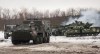 Ukrainian armored vehicles drive during military drills close to Kharkiv, Ukraine, Thursday, Feb. 10, 2022.&nbsp;Britain's envoy to Canada says the two countries are cooperating on a tough new set of sanctions against Russia if it invades Ukraine. (AP Photo/Andrew Marienko)