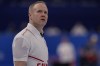 Canada's Mark Nichols looks at a screen during a men's curling match against the United States at the Beijing Winter Olympics Sunday, Feb. 13, 2022, in Beijing. (AP Photo/Brynn Anderson)