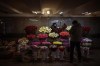 A woman prepares a bunch of flowers for a customer in downtown Kyiv, Ukraine, Monday, Feb. 14, 2022. More NATO troops headed to Eastern Europe and some nations worked to move their citizens and diplomats out of Ukraine on Monday, as Germany's chancellor made a last-ditch attempt to head off a feared Russian invasion that some warn could be just days away. (AP Photo/Emilio Morenatti)