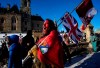 A protester yells “freedom” towards a person who attempted to stick a paper sign on a truck criticizing the so called “Freedom Convoy,” a protest against COVID-19 measures that has grown into a broader anti-government protest, on its 18th day, in Ottawa, on Monday, Feb. 14, 2022. THE CANADIAN PRESS/Justin Tang