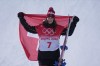 Gold medal winner Switzerland's Mathilde Gremaud celebrate during the venue award ceremony for the women's slopestyle finals at the 2022 Winter Olympics, Tuesday, Feb. 15, 2022, in Zhangjiakou, China. (AP Photo/Lee Jin-man)