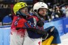 Bronze medal winner Ilia Burov, of the Russian Olympic Committee, left, hugs silver medal winner Ukraine's Oleksandr Abramenko as they celebrate after the men's aerials finals at the 2022 Winter Olympics, Wednesday, Feb. 16, 2022, in Zhangjiakou, China. (AP Photo/Gregory Bull)