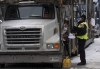 A police officer speaks with a trucker as he distributes a notice to protesters, Wednesday, Feb. 16, 2022 in Ottawa. THE CANADIAN PRESS/Adrian Wyld