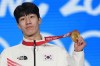 Gold medalist Hwang Dae-heon of South Korea celebrates during the medal ceremony for the men's 1500-meters short track speedskating during the 2022 Winter Olympics, Thursday, Feb. 10, 2022, in Beijing. (AP Photo/Jae C. Hong)