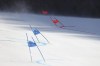 Gate flags bend in the wind after high winds caused a delay in the start of the mixed team parallel skiing event at the 2022 Winter Olympics, Saturday, Feb. 19, 2022, in the Yanqing district of Beijing. (AP Photo/Alessandro Trovati)