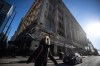 A person walks past the Hudson's Bay building in downtown Vancouver, on Wednesday, February 23, 2022. Hudson's Bay Company and RioCan Real Estate Trust have partnered to redevelop the historic building, adding an office tower and retaining the century-old heritage exterior. THE CANADIAN PRESS/Darryl Dyck